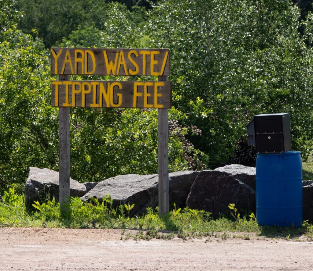 HSU Growing Supply yard with bulk compost, mulch and soil bins, loader area, and on-site signage in Wausau, WI.