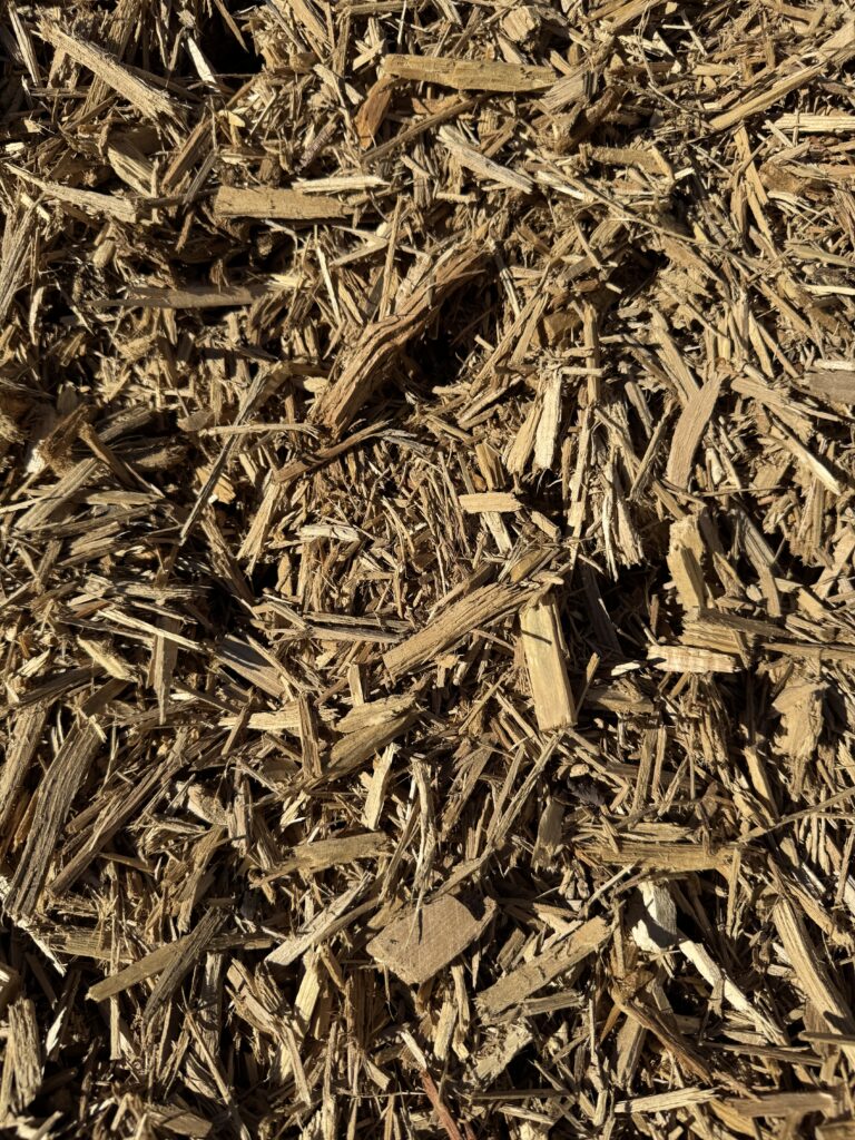 Close-up of HSU Growing Supply Amber colored mulch.
