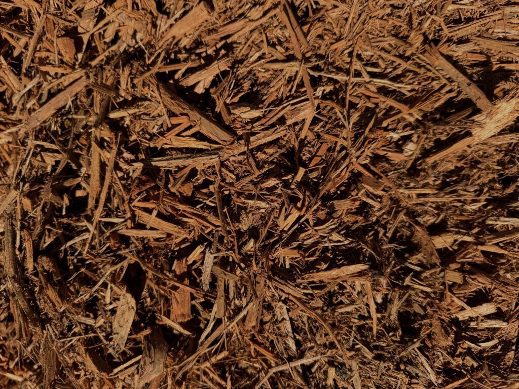 Close-up of HSU Growing Supply Amber colored mulch.” Title: “HSU Amber Mulch